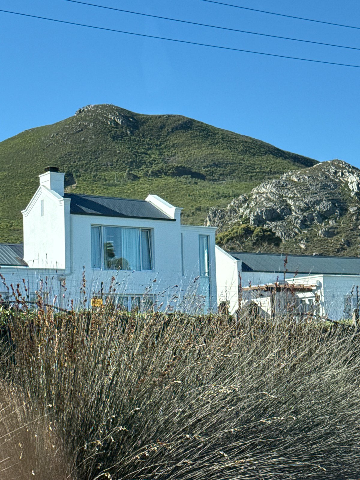 Modern house photographed against verdant mountain in South Africa