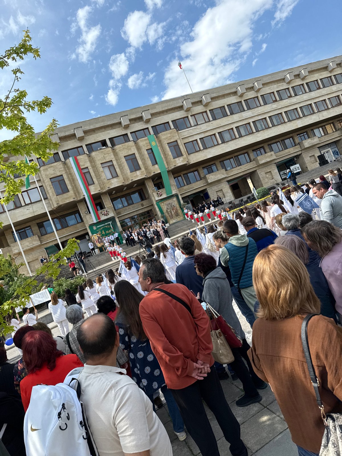 Crowd gathers at flag-decorated government building in Shumen, Bulgaria