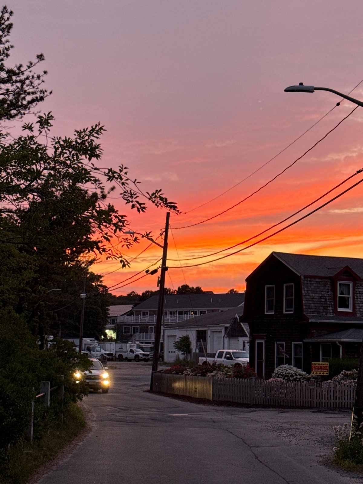 Provincetown street glows under a vivid summer sunset