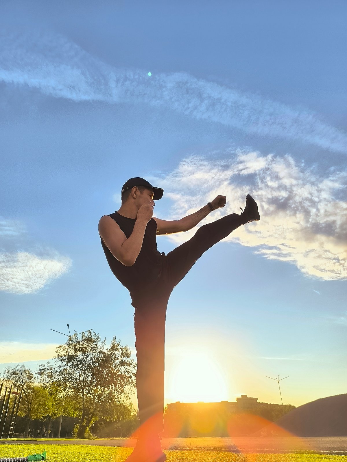 Martial arts training at sunset on a Qarağandı turf field