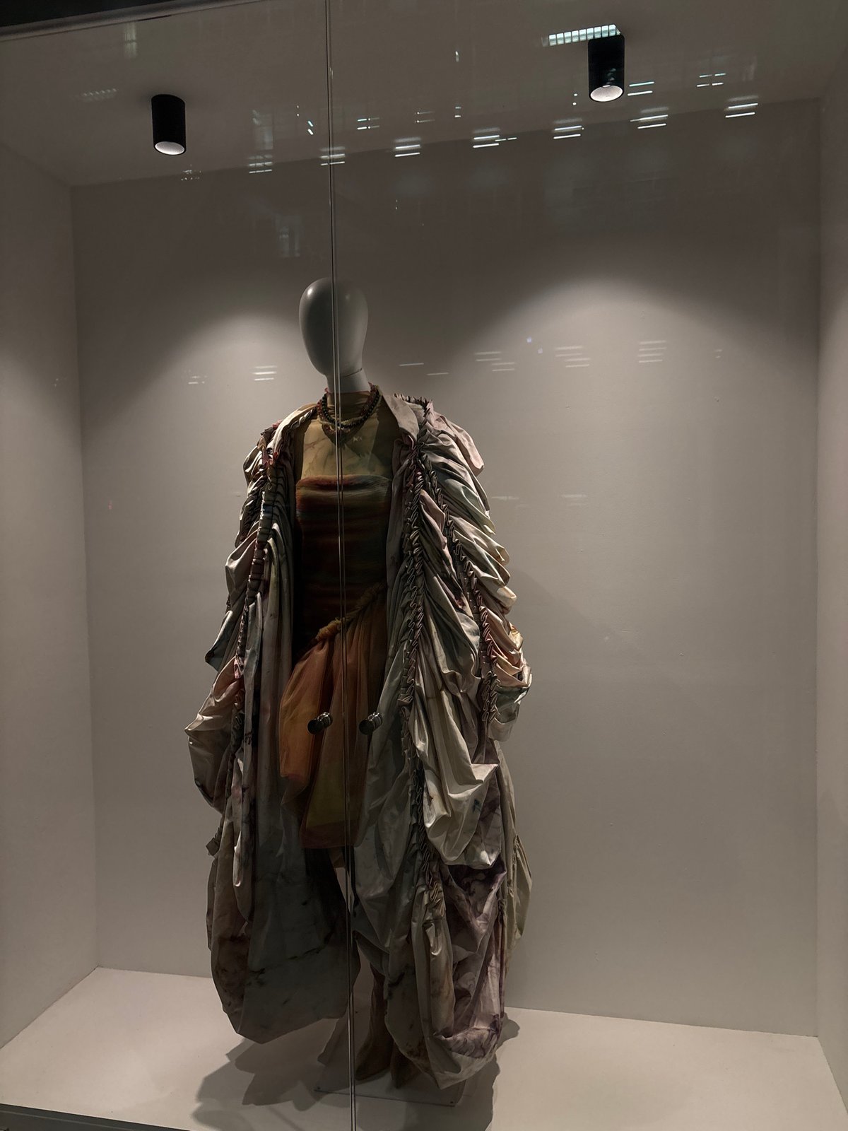 Elaborate garment exhibited in glass case at Mexico City museum
