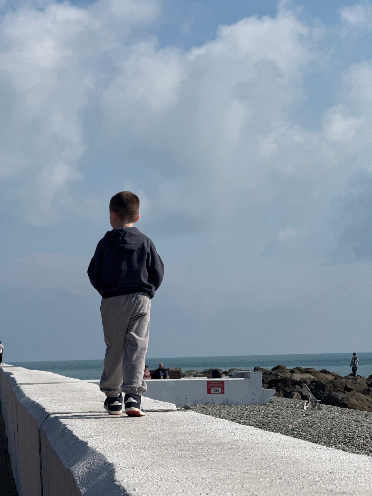 Boy watches sea from promenade in Sirius, Russia