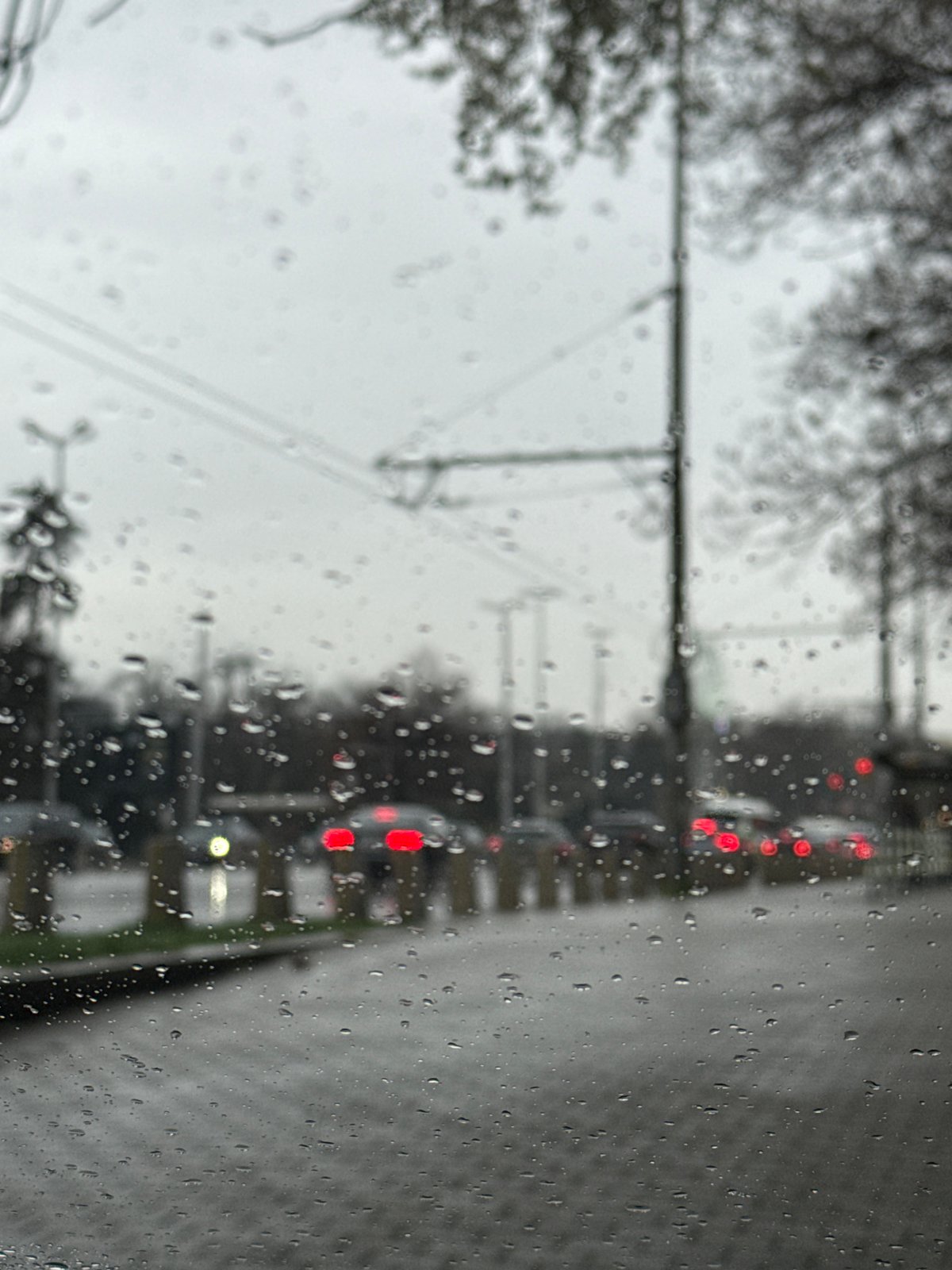 Rainy day traffic scene captured through window in Sofia