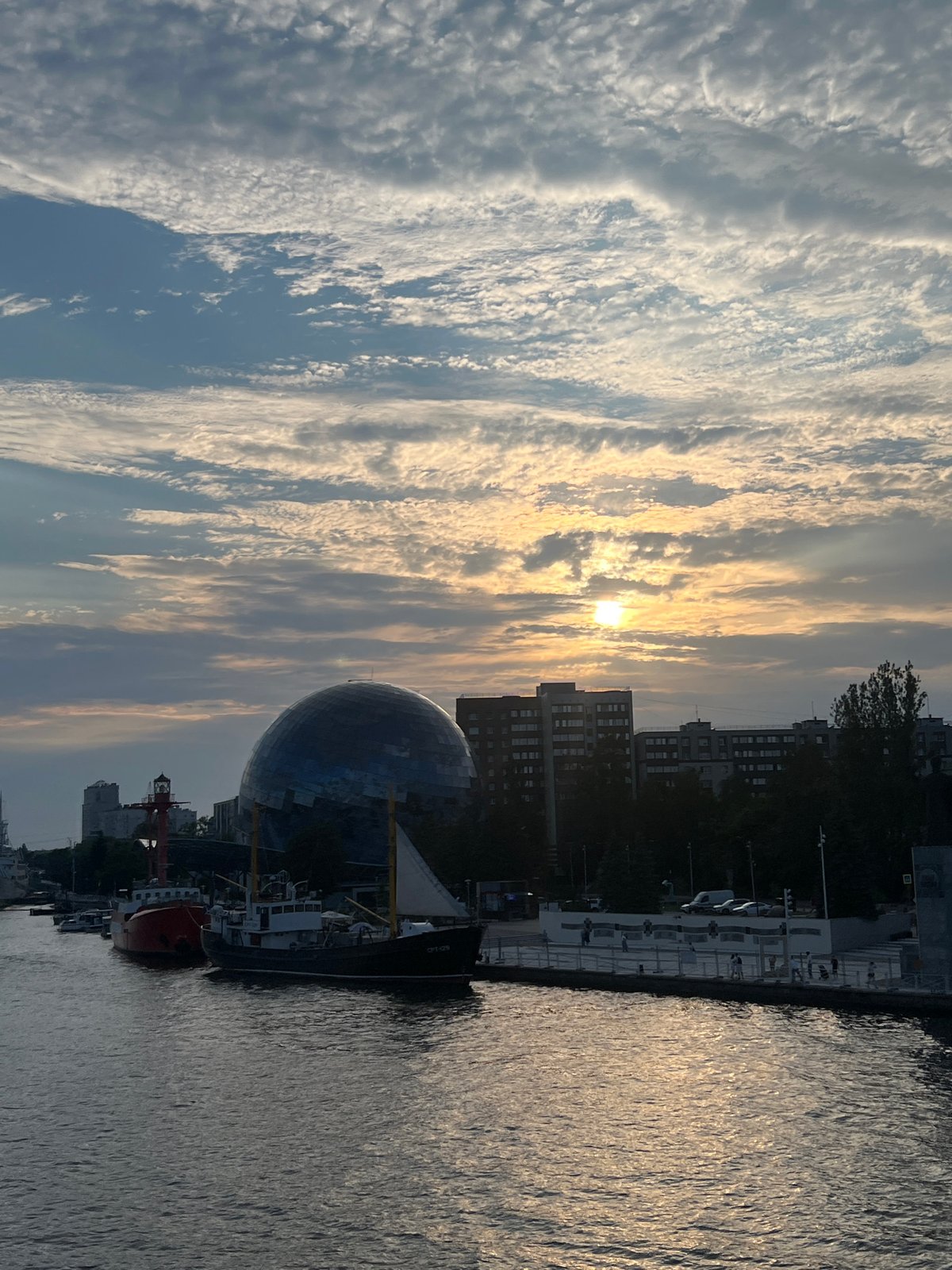 Kaliningrad waterfront at sunset, boats and landmarks in view