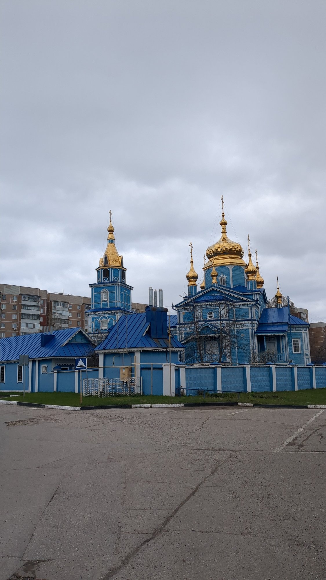 Blue wooden Orthodox church with golden domes documented in Ulyanovsk