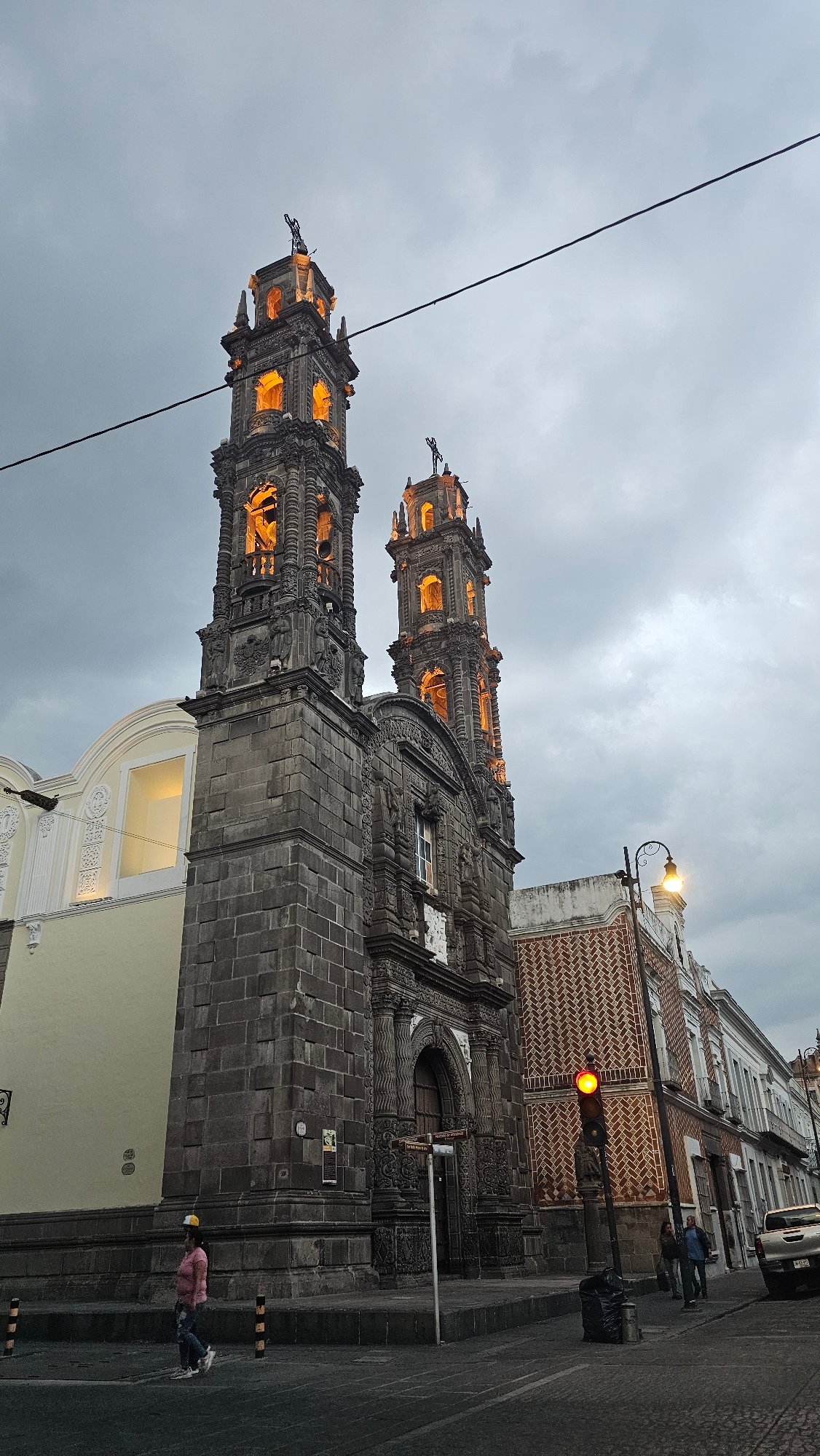 Twin-towered church photographed on Puebla street at dusk