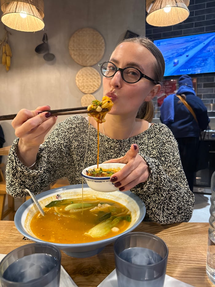 Woman dines at Paris restaurant, soup and drinks observed