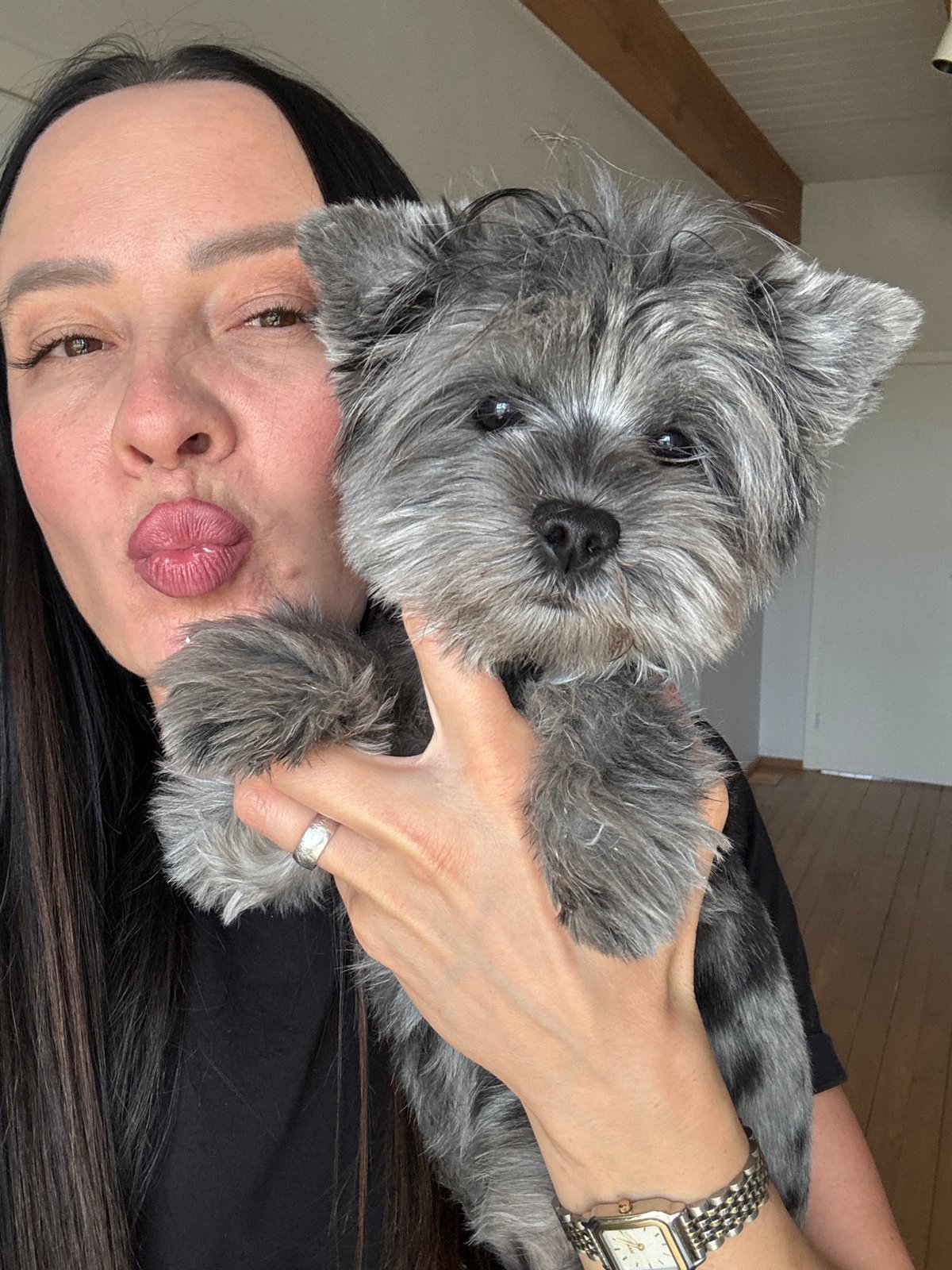 Woman photographed with small dog indoors in Chaikovsky