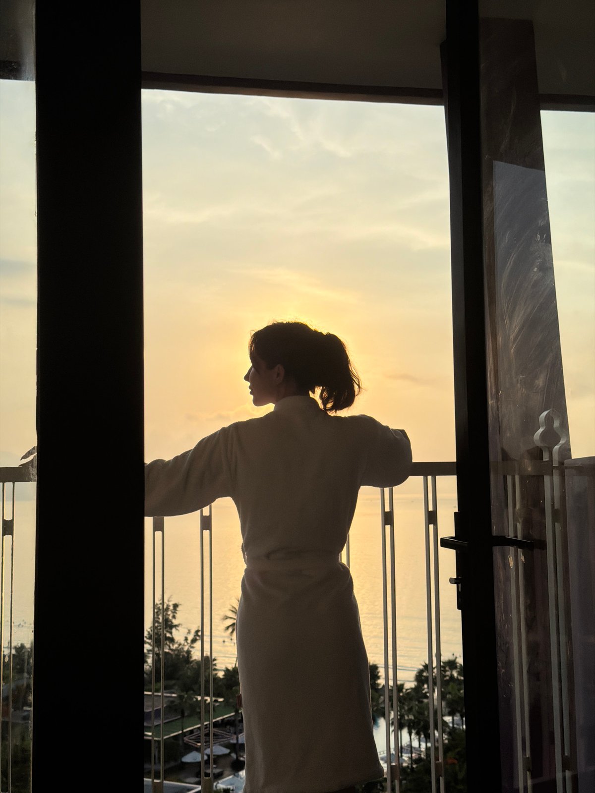 Sunset silhouette observed from high-rise balcony in Vietnam