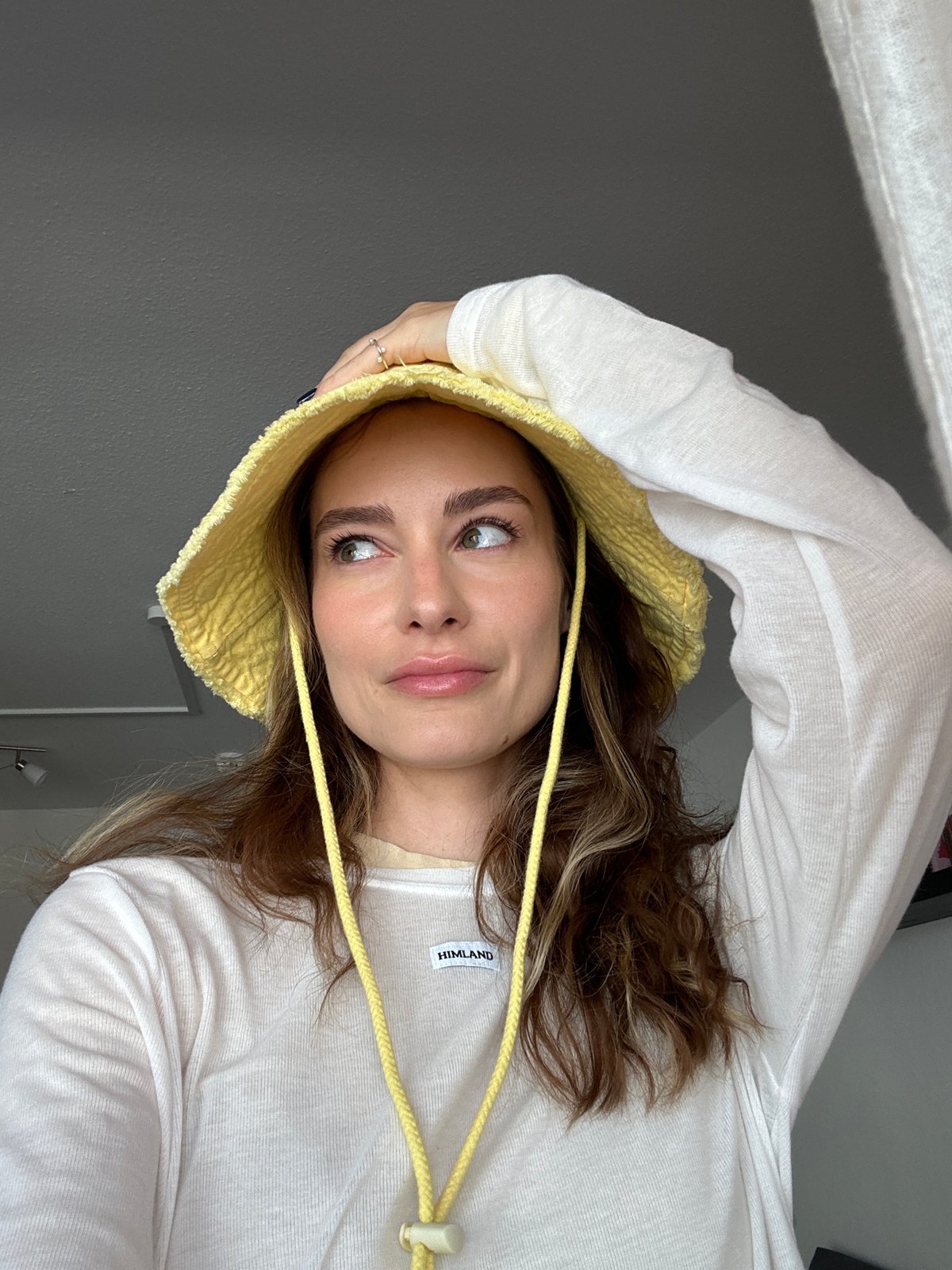 Woman poses for portraits in yellow hat in Kiel