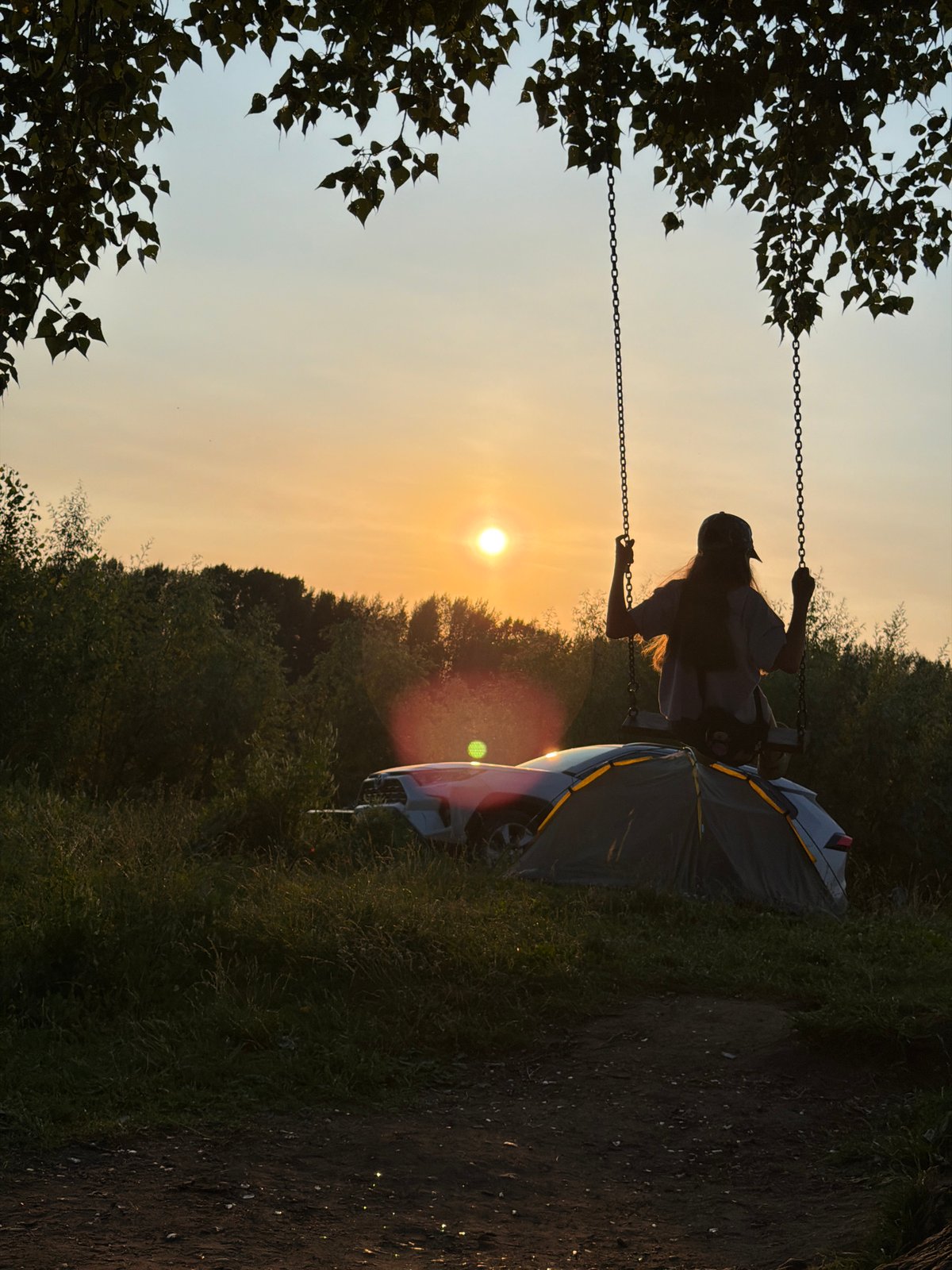 Swing, tent, and golden hour at a Chaikovsky outdoor hangout