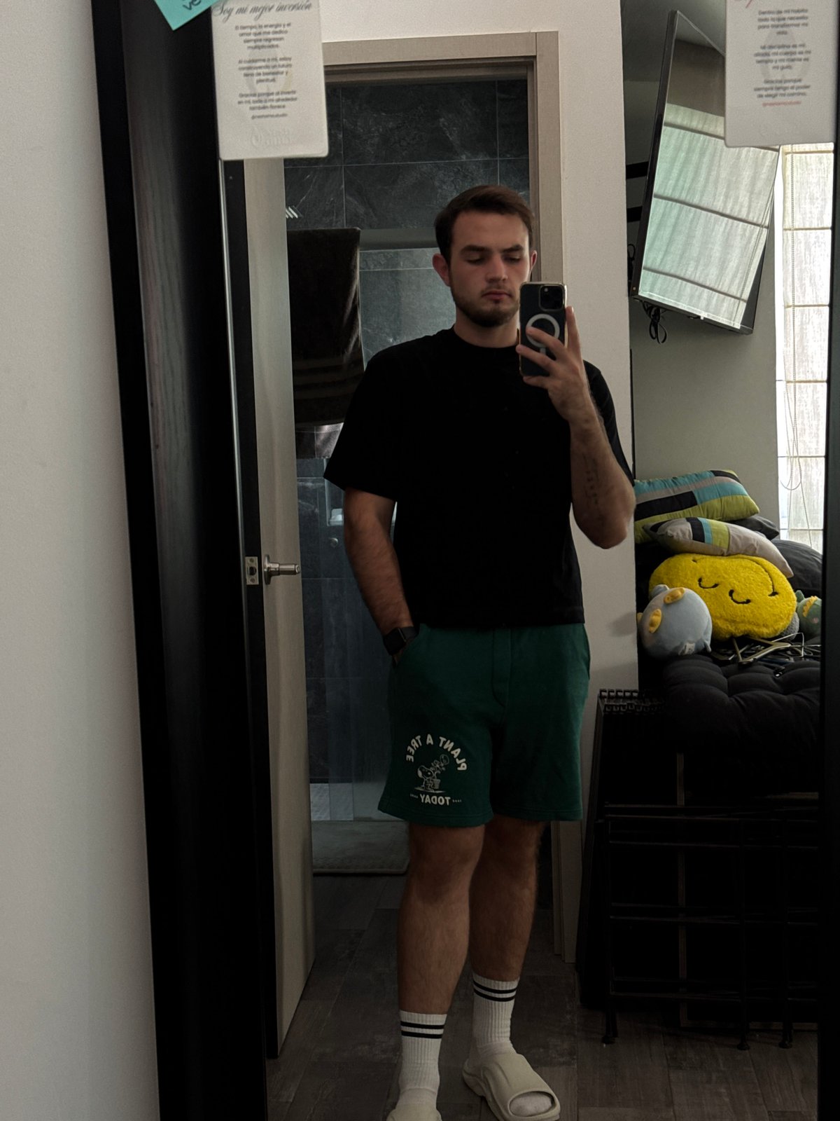 Man takes mirror selfie in Mexican home