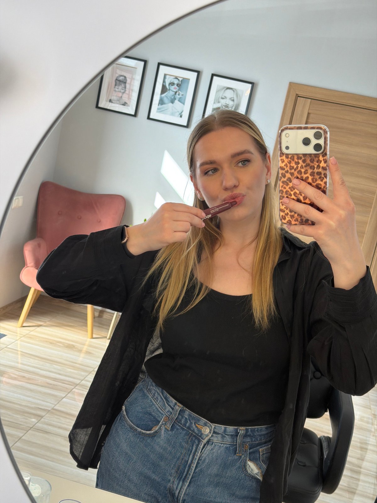 Woman takes mirror selfie during morning routine in Riga