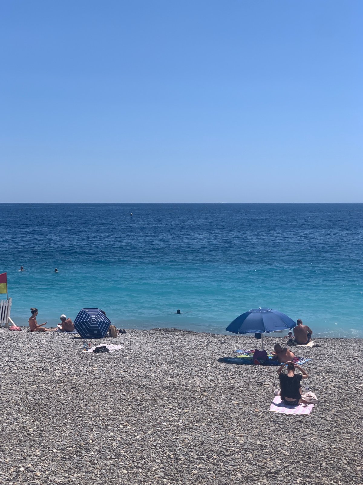 Sunny afternoon on Nice's pebble beach, Mediterranean in full color