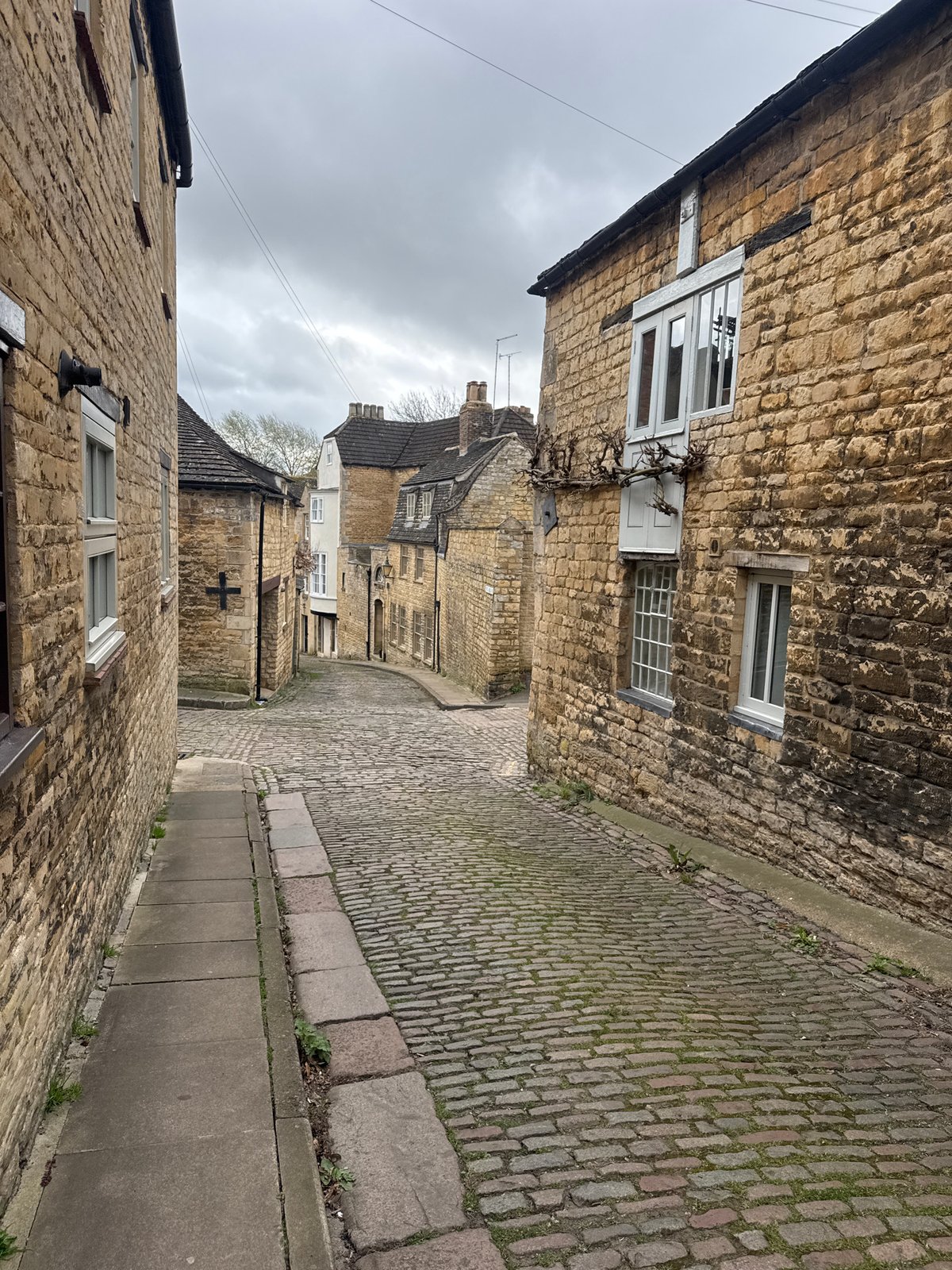 Cobblestone street with stone buildings observed in South Kesteven