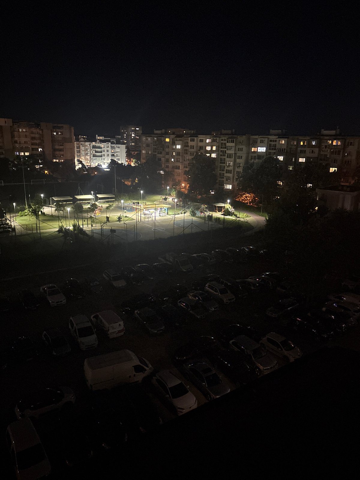 Nighttime aerial views of a residential neighborhood with a park