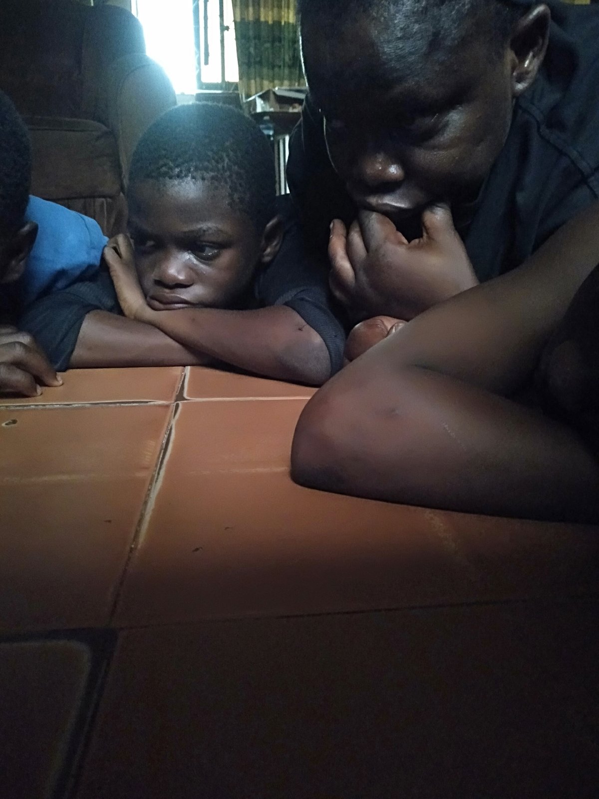 Children rest indoors during afternoon in Shangisha, Nigeria