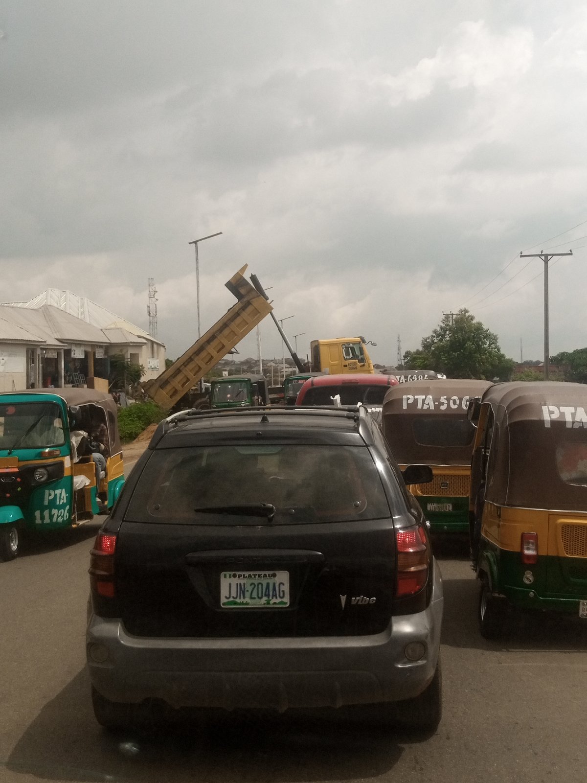 Afternoon street traffic and daily movement in a Nigerian urban area