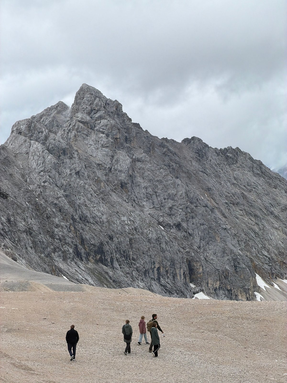 Hikers and a mountain chapel on rocky terrain near Garmisch-Partenkirchen