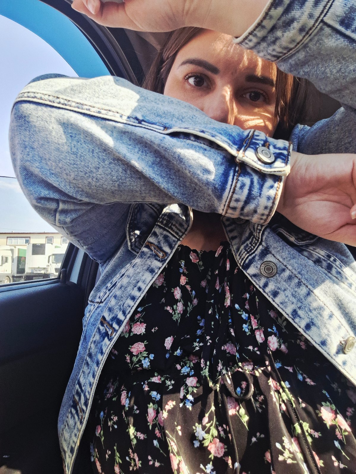 Woman in floral dress documented near vehicle in Izhevsk