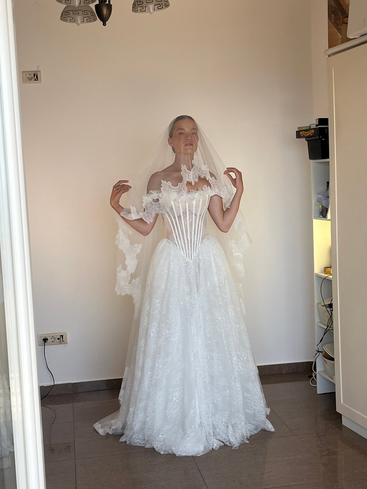 Bride poses for wedding photos in Budva indoor session