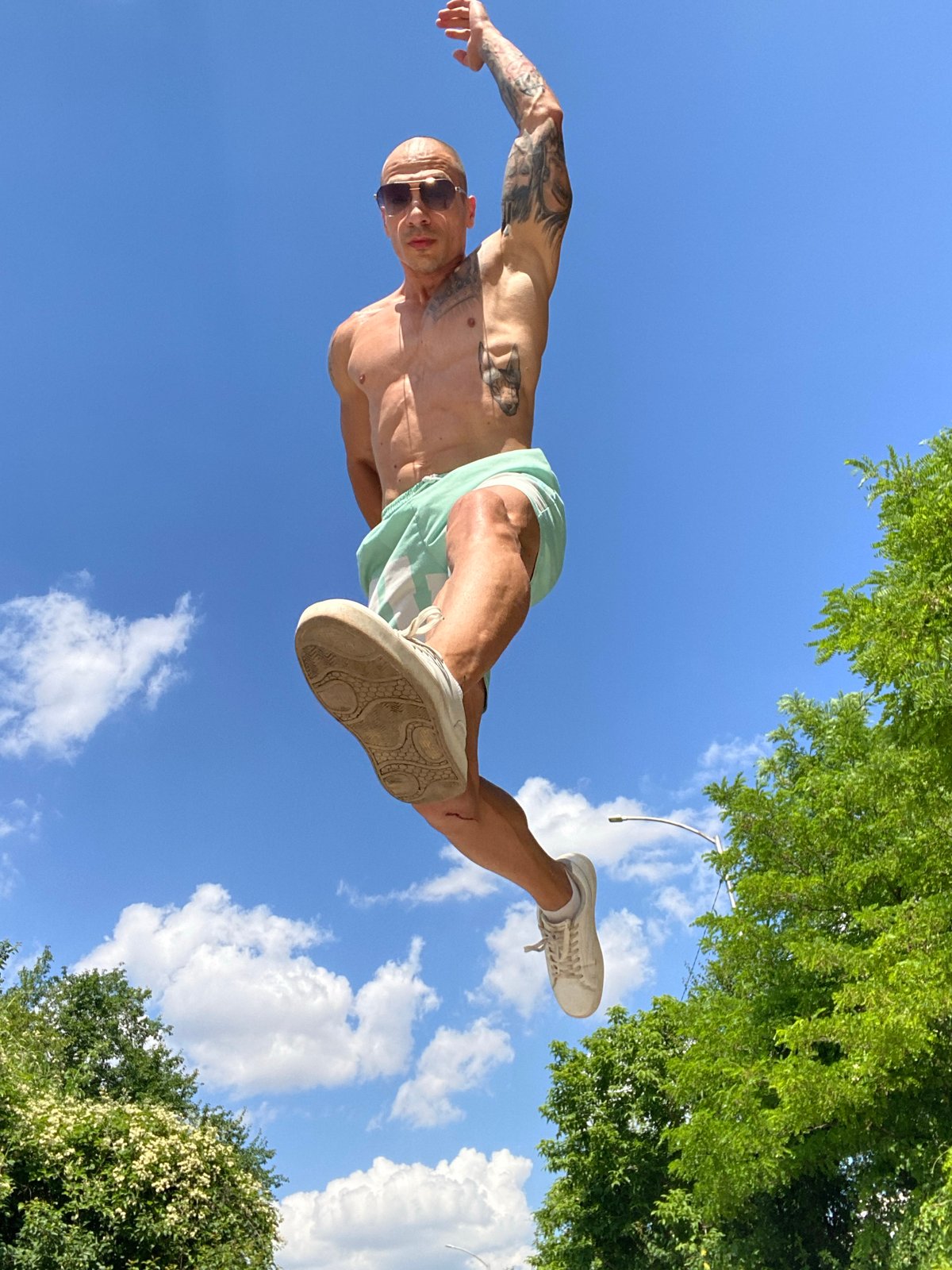 Tattooed, shirtless and jumping on a sunny Pleven street