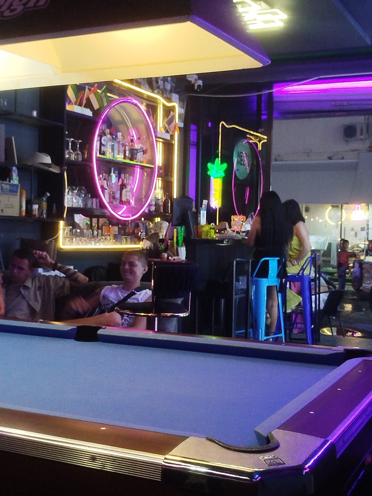 Evening pool hall session at a neon-lit Patong bar