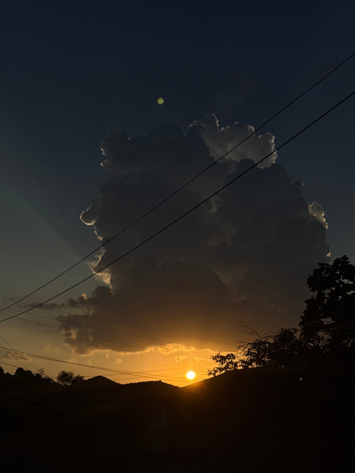 Storm cloud backlit by setting sun over central Bulgaria
