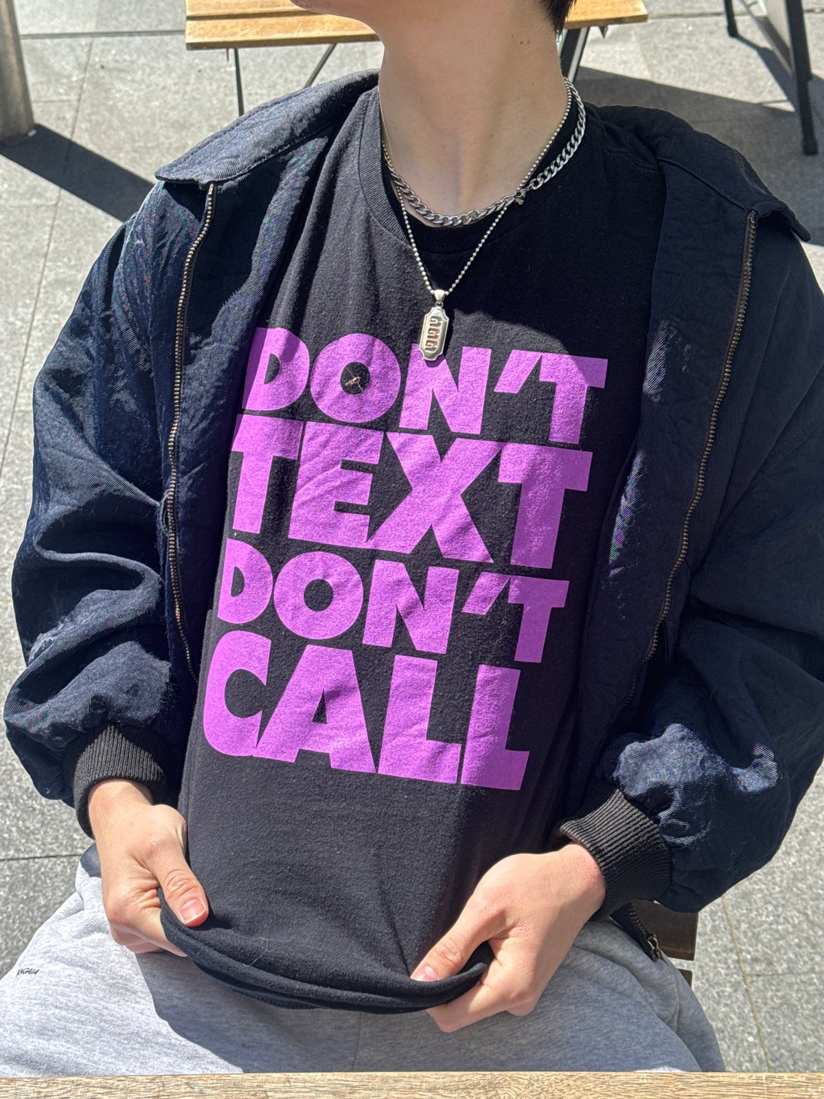 Person in "DON'T TEXT DON'T CALL" shirt spotted in London