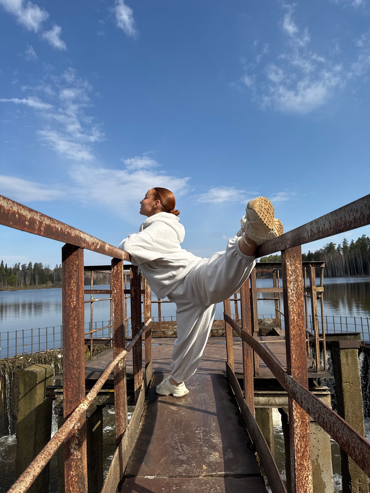 Woman performs balancing act on metal structure in Opary