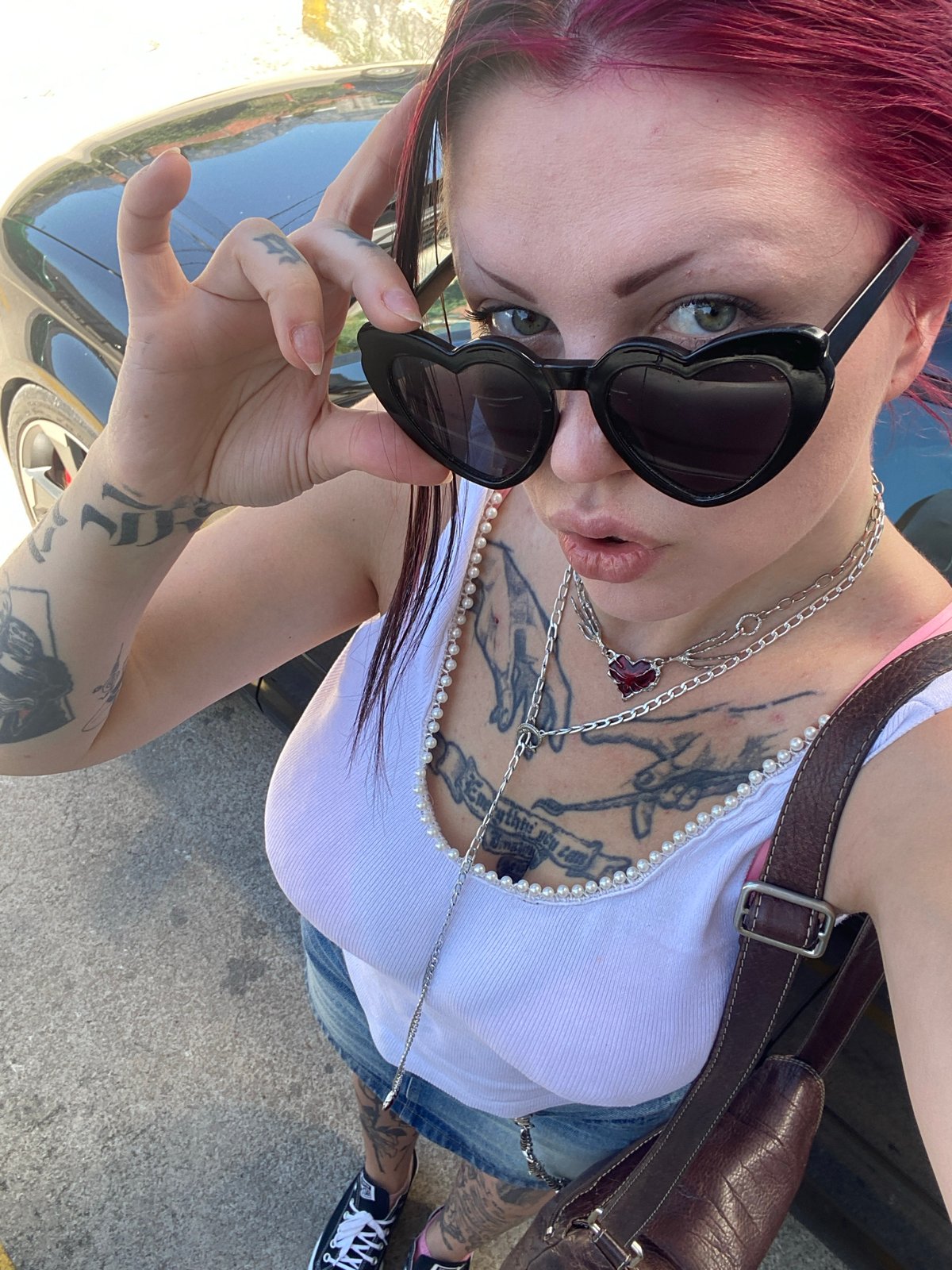 Woman takes selfies in heart sunglasses in Montenegro village