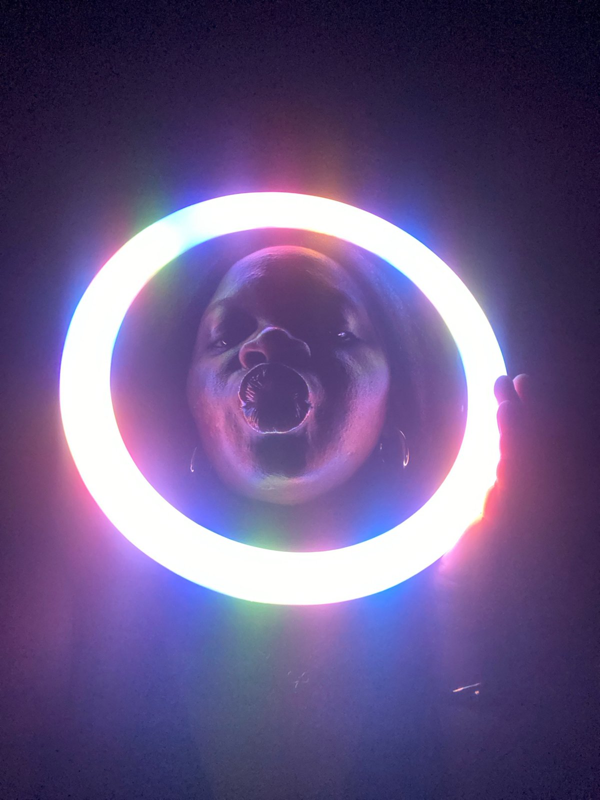 Person experiments with LED ring light and lasers in Nigeria