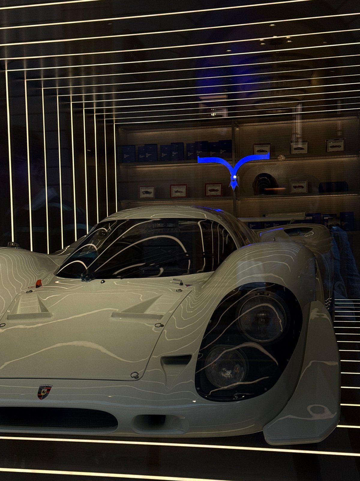 White sports car displayed in Milan showroom exhibit