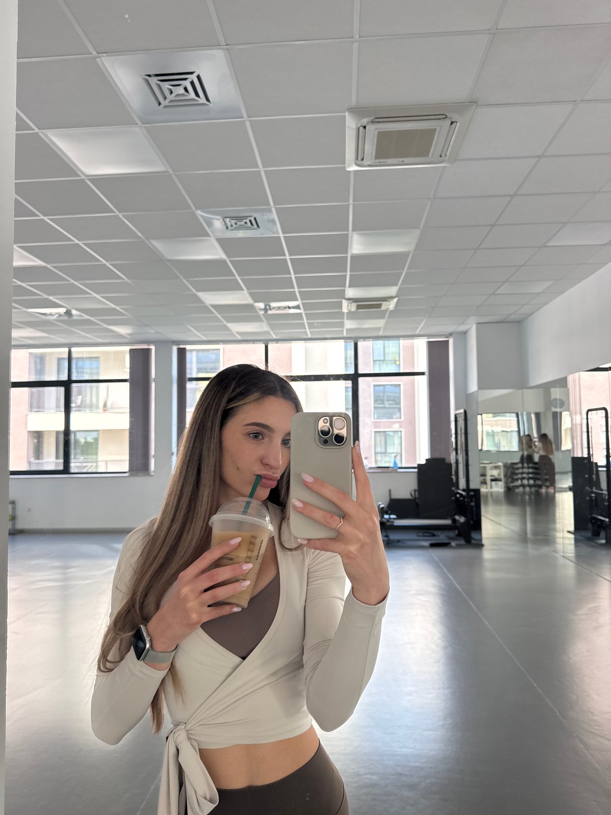Woman Takes Coffee Break Selfies at Sofia Fitness Studio