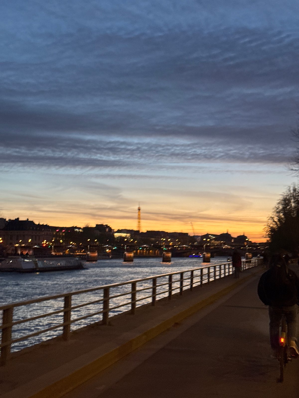 Evening light illuminates Paris streets and Seine River