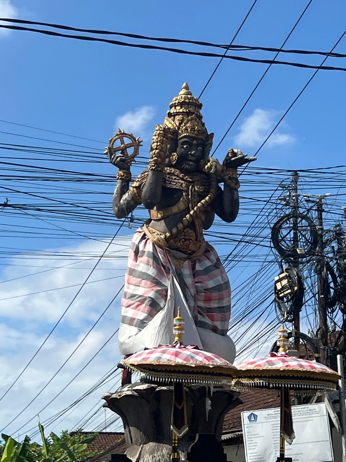 Multi-faced Hindu statue anchors a busy North Kuta intersection