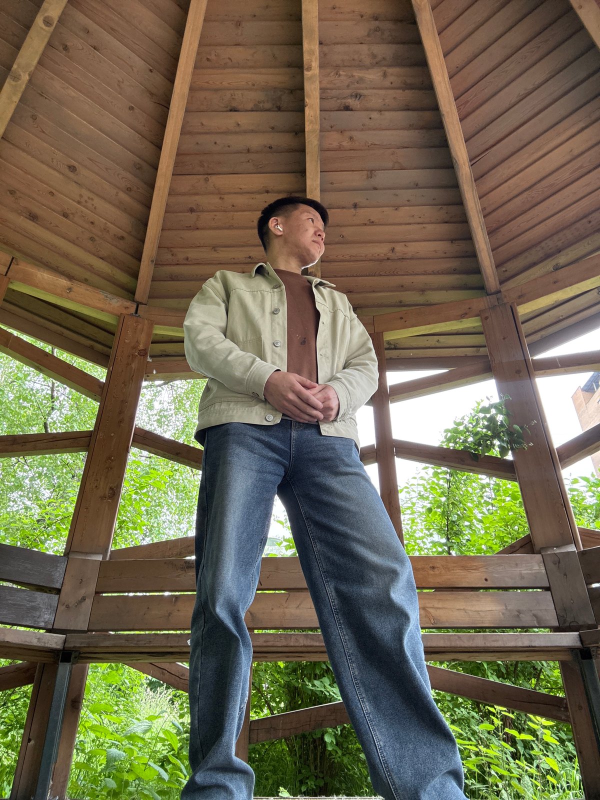 Young person photographed in wooden gazebo in Moscow