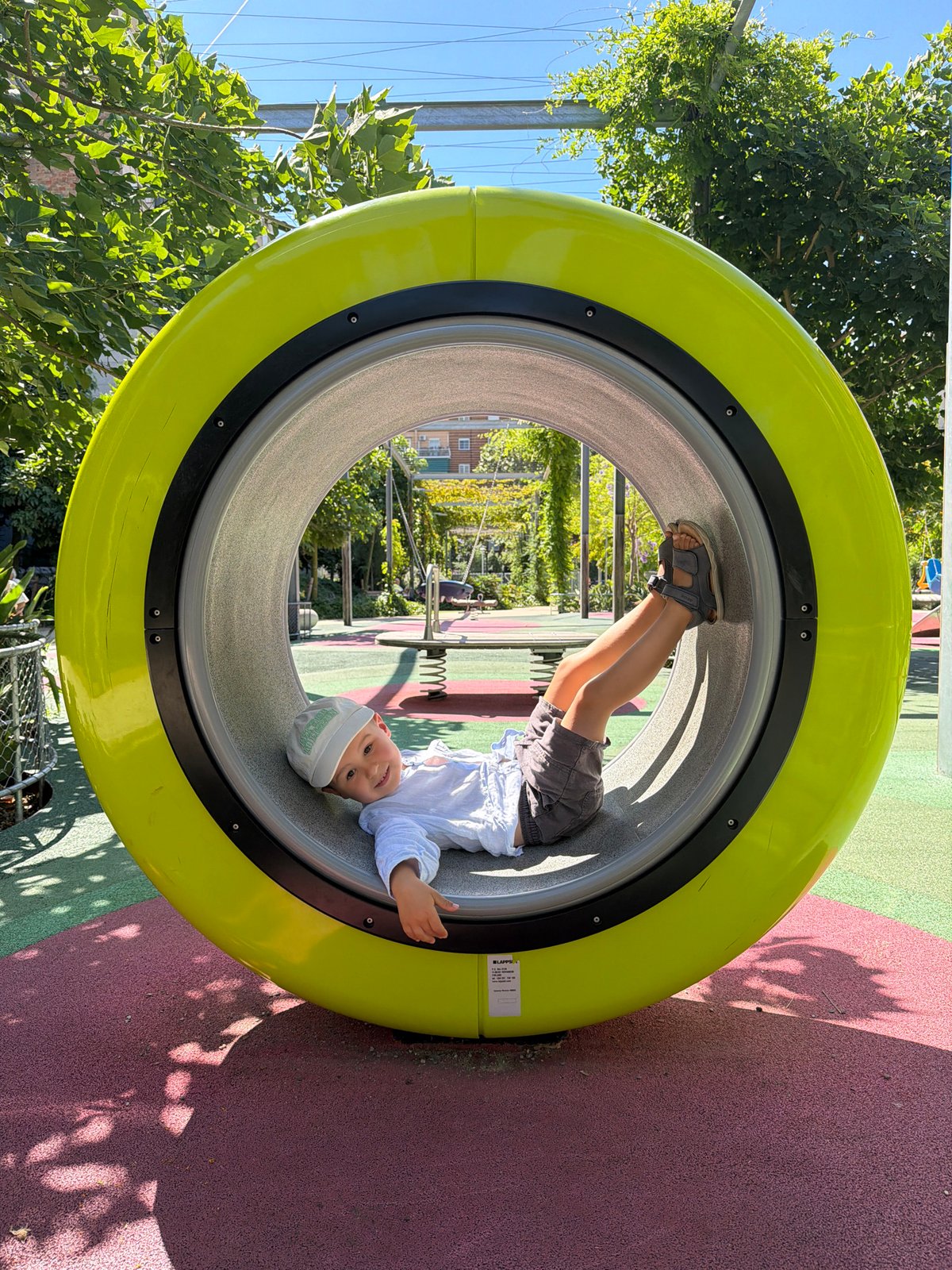 Child plays at modern Barcelona playground Saturday morning