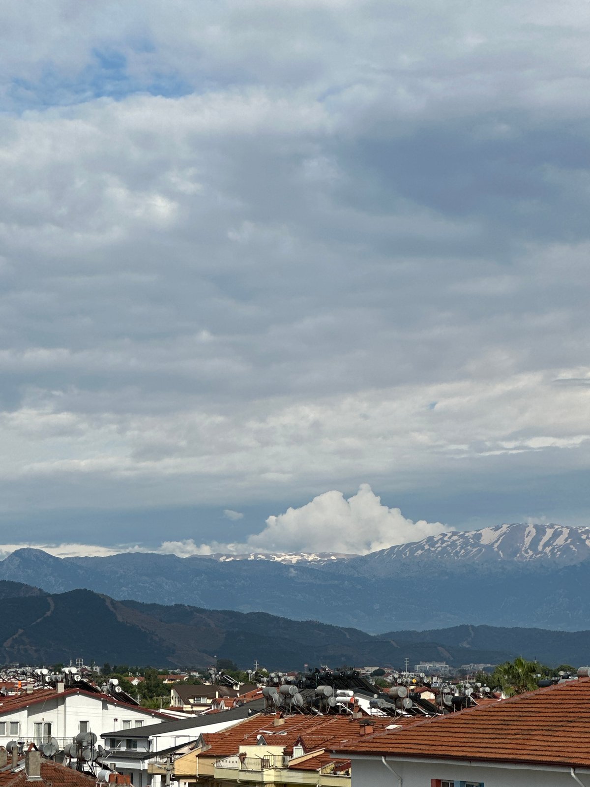Elevated view captures Fethiye cityscape under cloudy Turkish skies