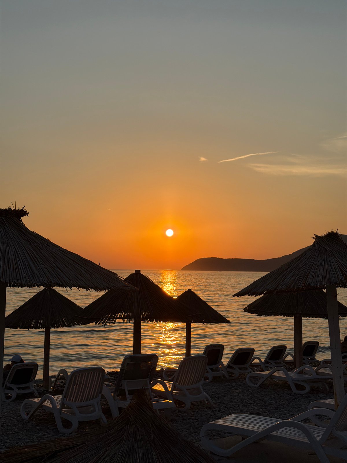 Empty beach chairs at sunset on Montenegro's Adriatic coast