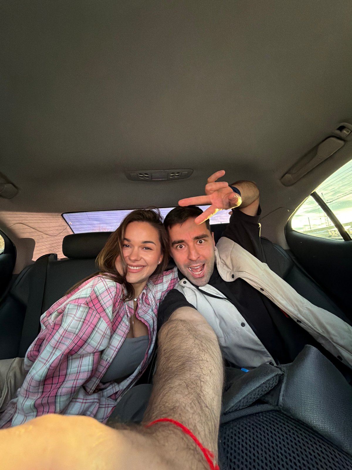 Couple shares playful moment in car backseat in Krasnoyarsk