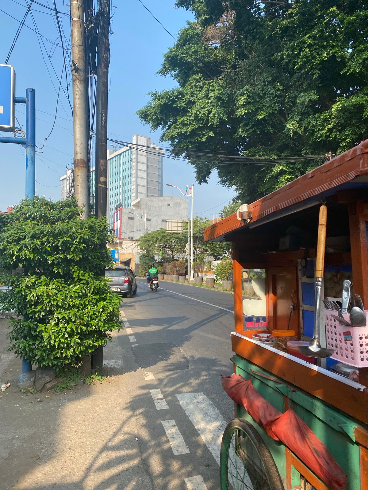 Sunny midday street life near Atika Hotel, East Jakarta
