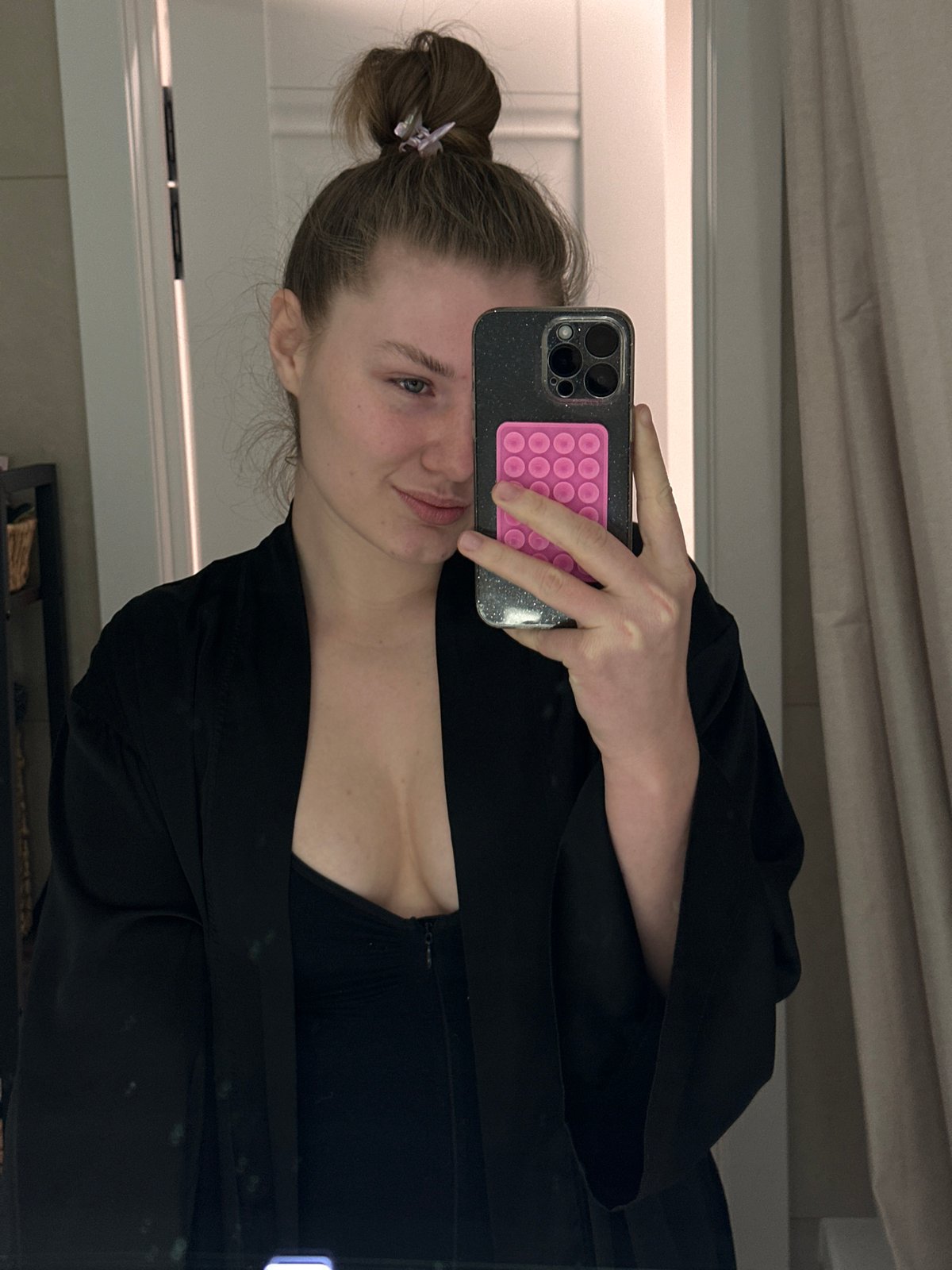 Person cleans mirror, takes bathroom selfie in Kazan
