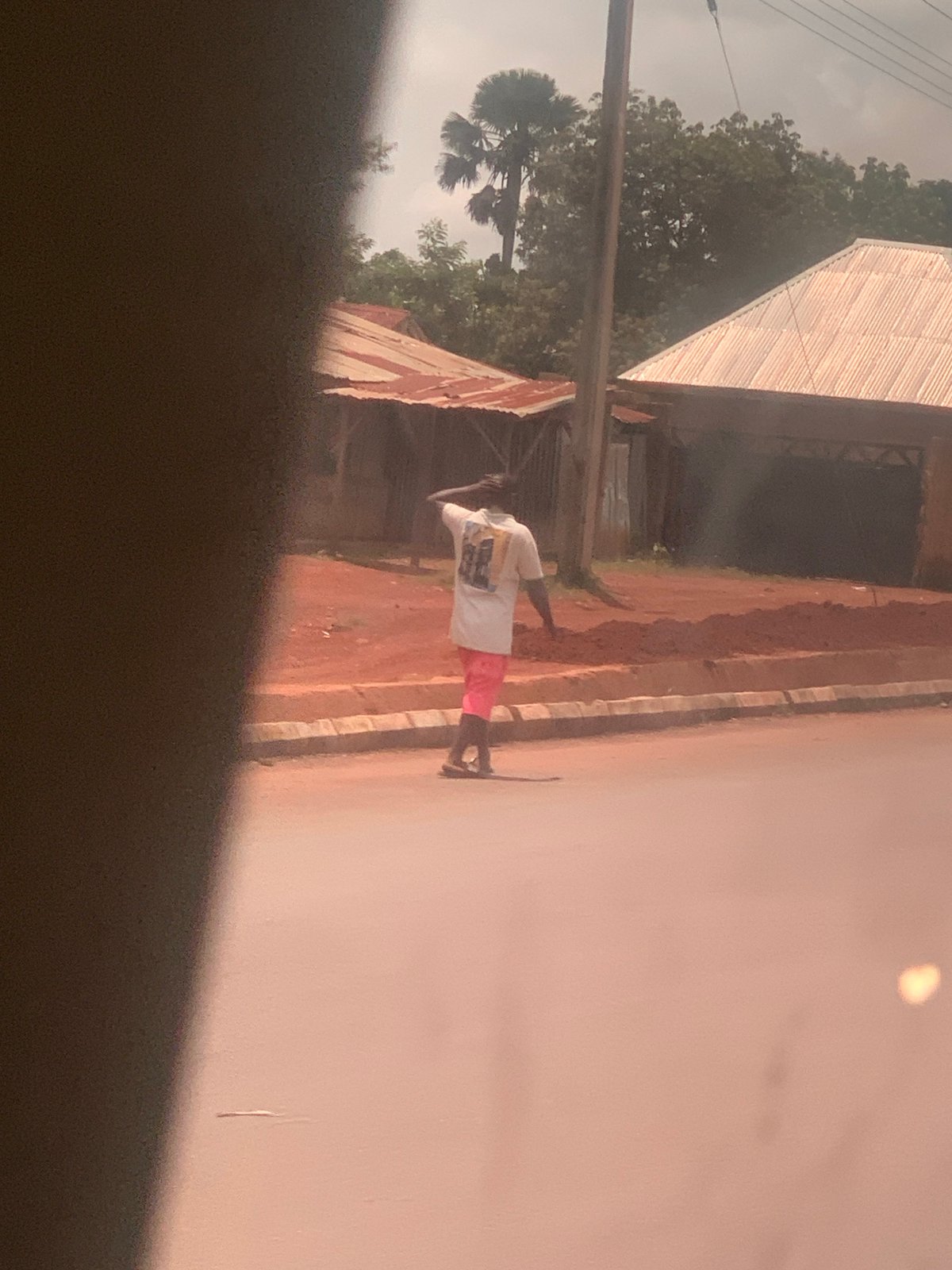 Everyday street life along a dusty road in Hoss, Nigeria