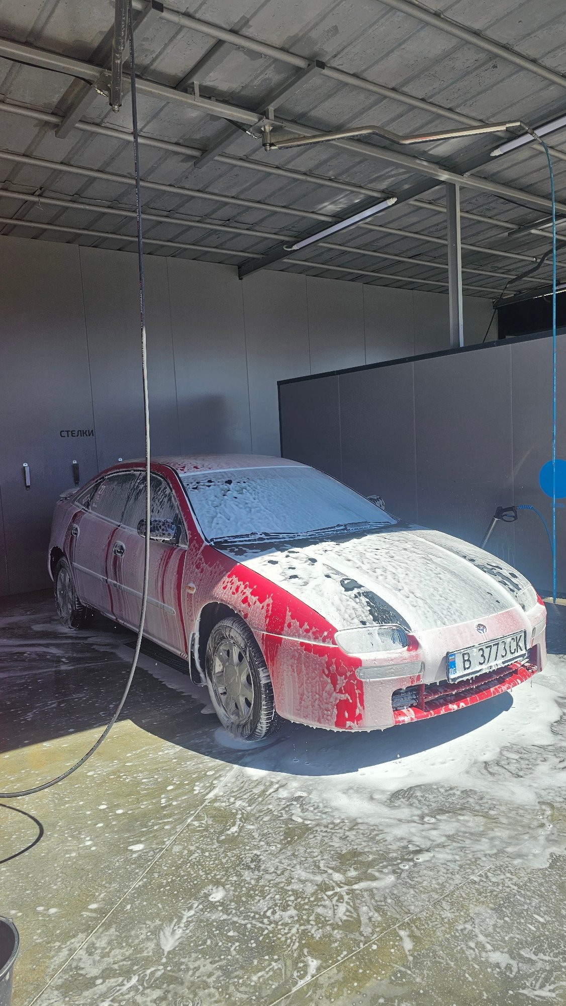 Red car washed at Varna Bulgaria car wash facility