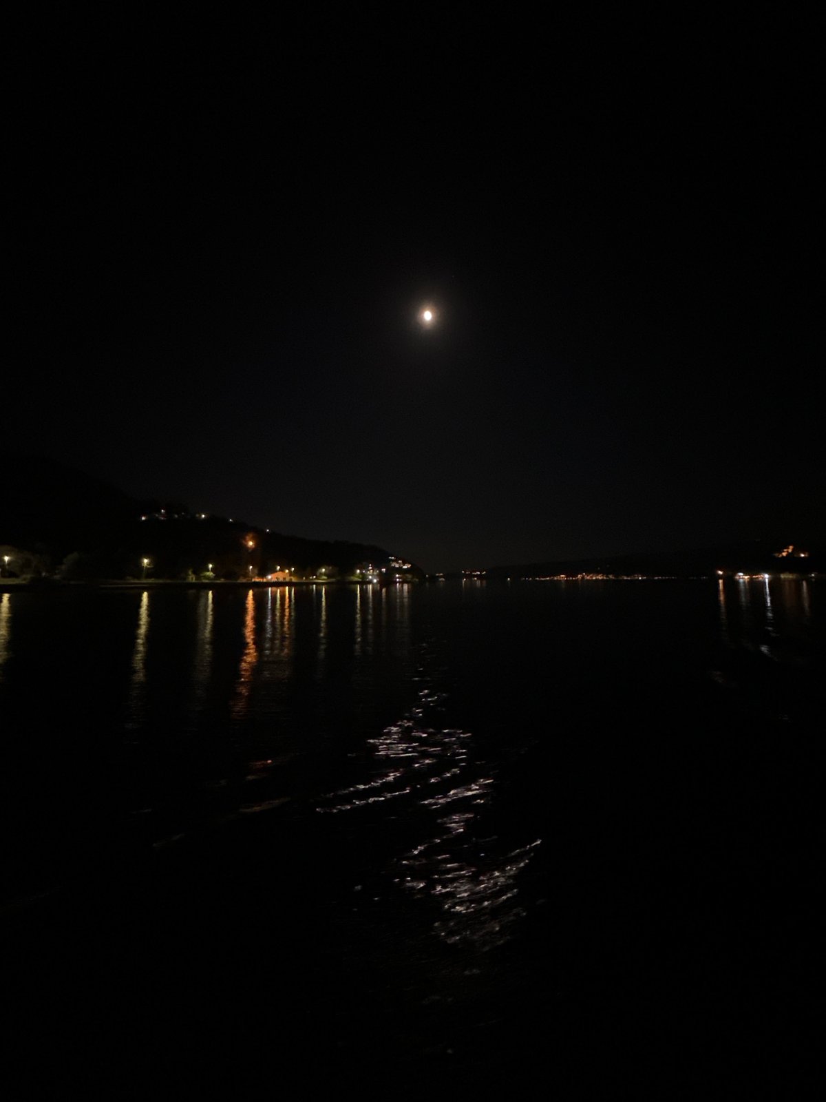 Ferry crossing captured under moonlight between Montenegro coastal towns