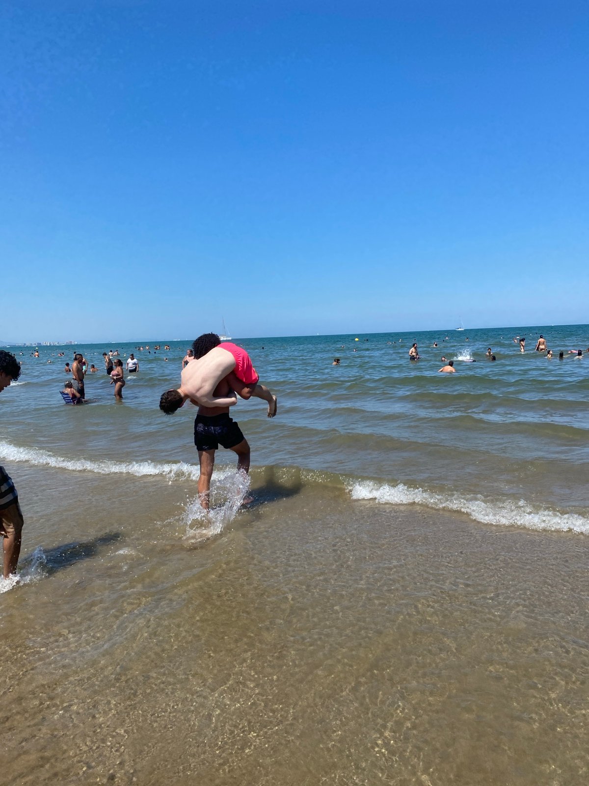 Packed summer afternoon on Valencia's sunny beachfront
