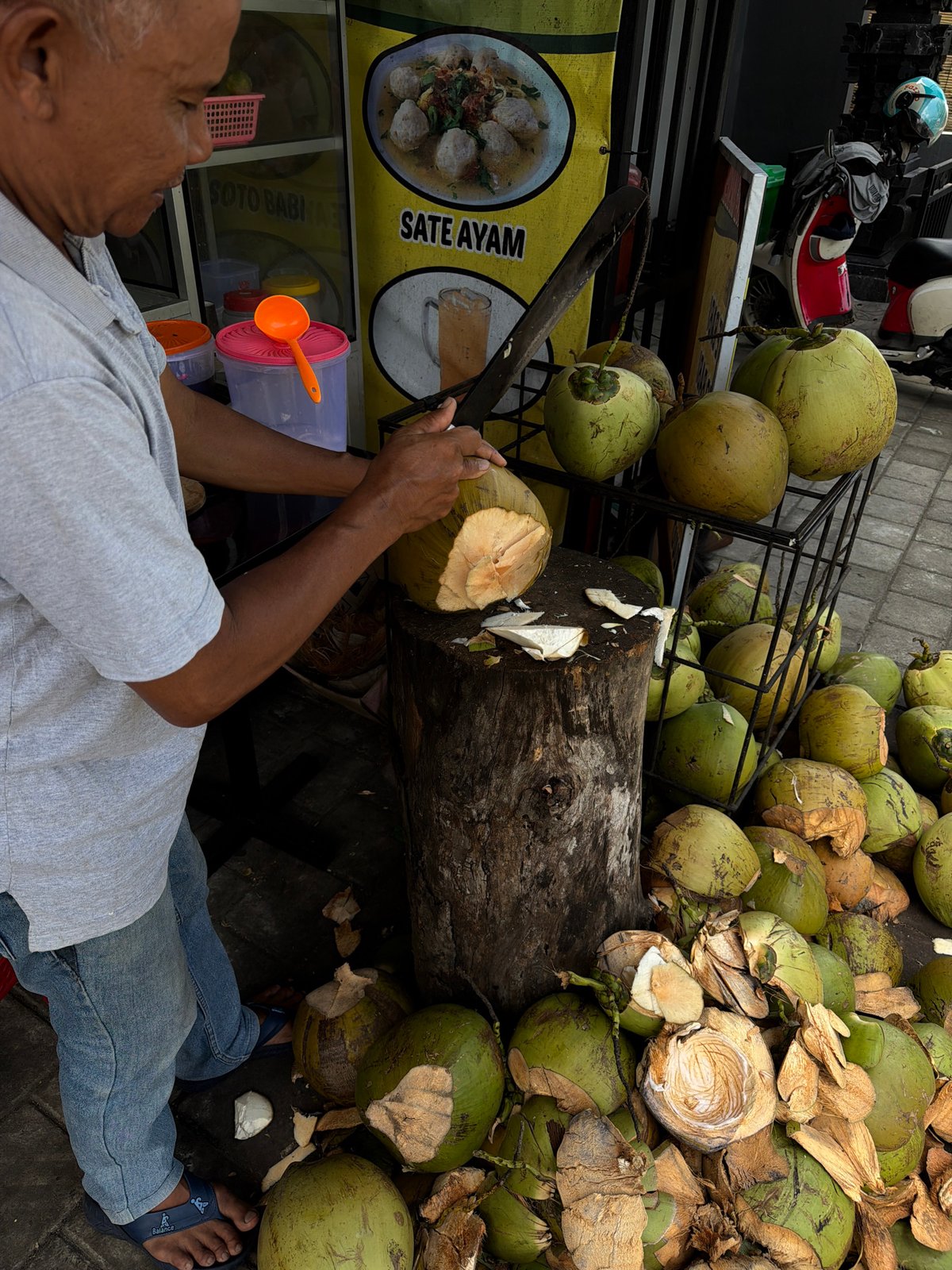 Man prepares coconut in Indonesian village