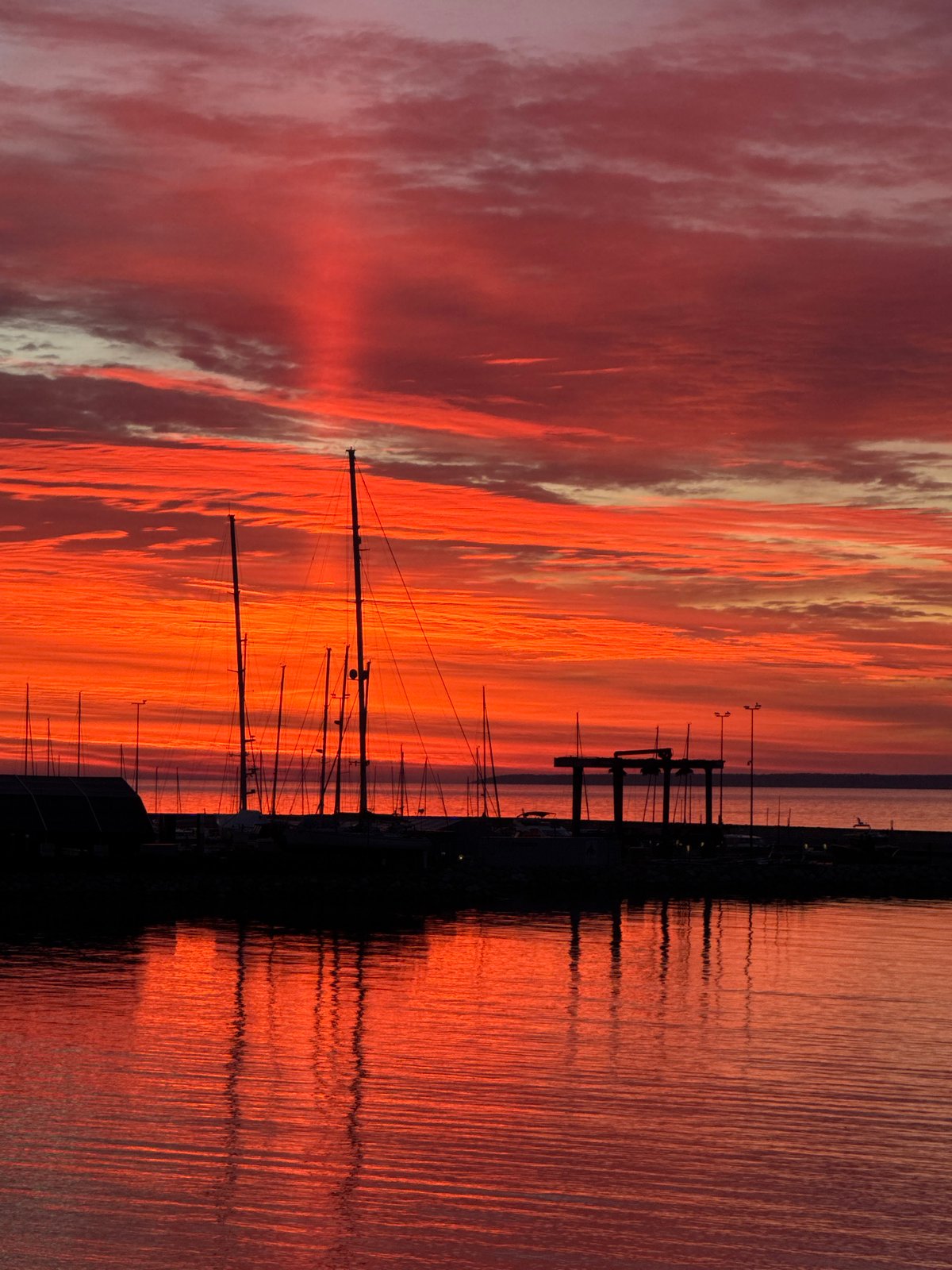 Dramatic sunset illuminates Tallinn's Baltic coastline and marina