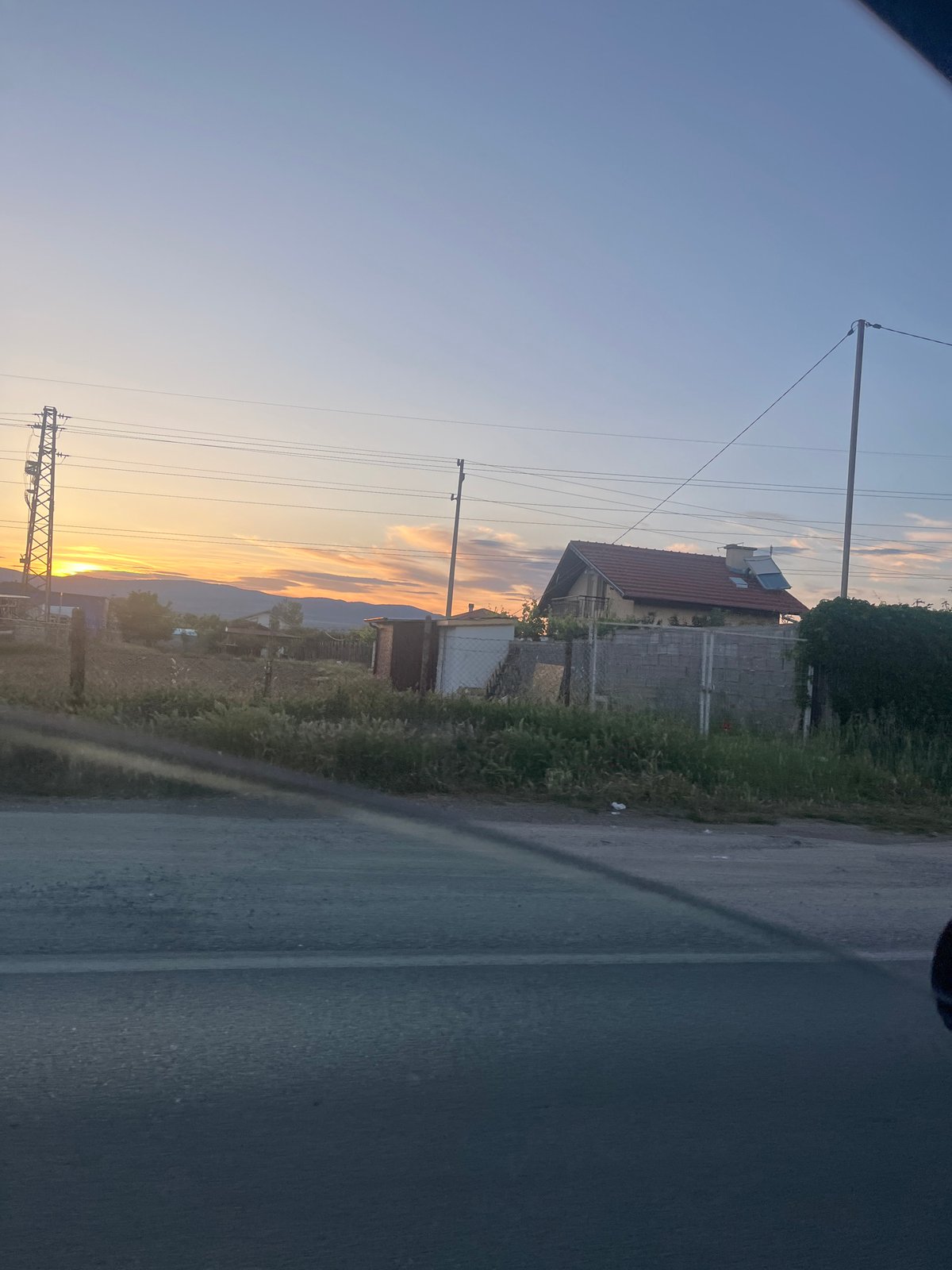 Sunset documented on Blagoevgrad street with cars and power lines